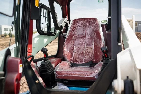 Cabin seat and joystick area inside the Lonking CDM312 mini skid steer loader.