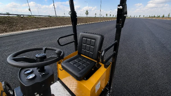 Operator seat and controls on the Bautrax DR10 tandem vibratory roller.