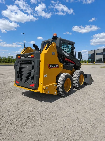 XCMG XC7-SR08 compact skid steer loader rear-left view showing chassis, tires and loader arms.