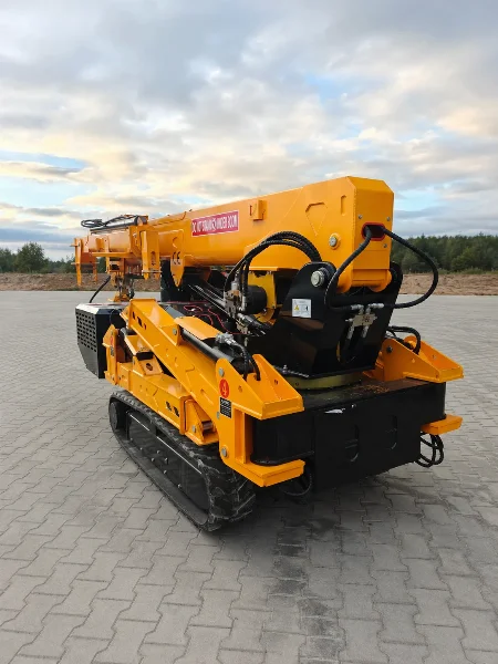 BAUTRAX SPC50 spider crane rear three-quarter view on rubber tracks at dusk